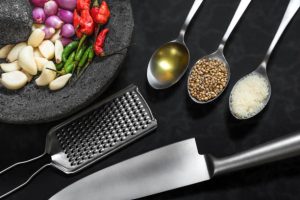 "Essential tools for cooking Statler chicken: roasting pan, thermometer, and knife." 