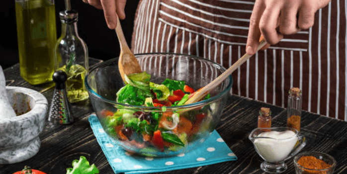 Step-by-step preparation of the Delicious Chicken Tahini Salad Dish, featuring fresh ingredients being mixed in a bowl, showcasing the vibrant colors and textures of the salad.